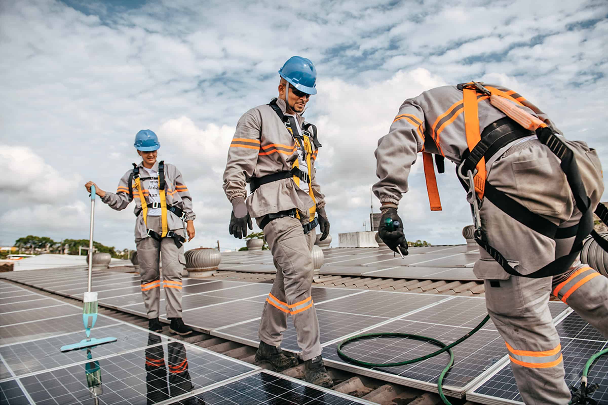 Operations and maintenance team members on a commercial roof